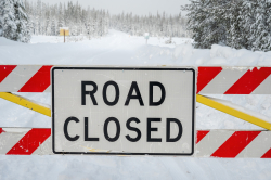 Closure gate with Road Closed sign at snow covered Cascade Lakes Highway