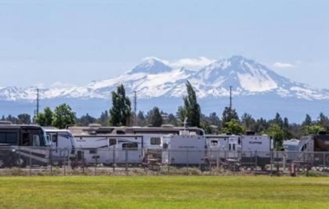 Photo of recreational vehicles at the park with mountains in the background