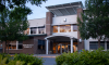 Exterior of Deschutes Services Building with trees and greenery in foreground