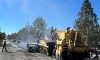 Asphalt truck & Pavement rollers installing pavement on Tumalo Reservoir Rd. 